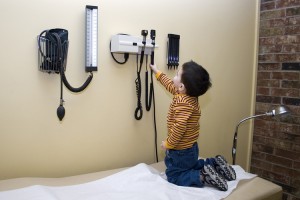 A boy exploring hospital equipment.