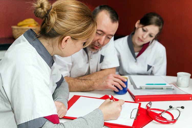 senior nurse giving feedback to colleague