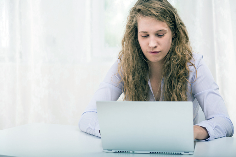 Woman using social media on a laptop