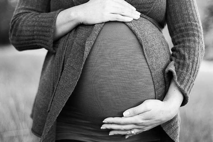 Pregnant woman holding her stomach