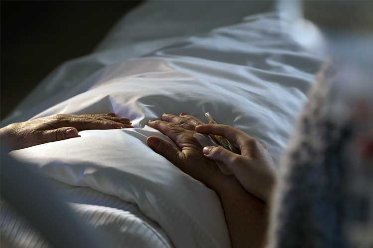 A patient being comforted in a hospital bed