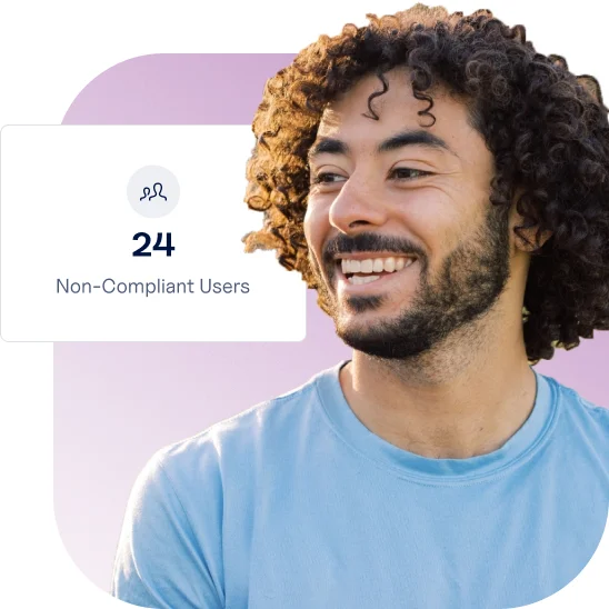 Smiling healthcare team leader reviewing Ausmed dashboard showing 24 non-compliant users in staff training compliance report